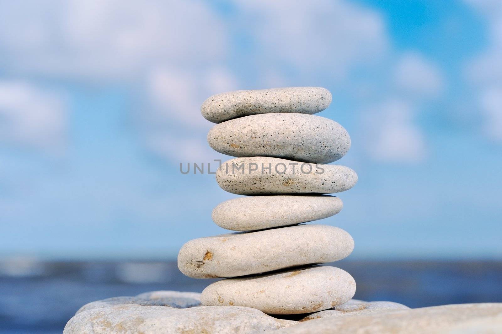 Six sea stones put against each other at the sea