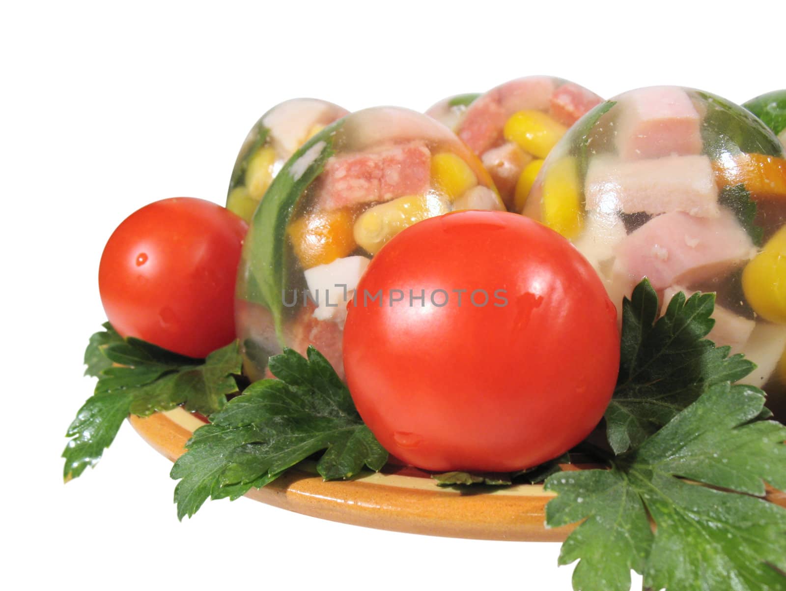 Appetizing jellied eggs with greens and tomatoes on a white background, with clipping path.