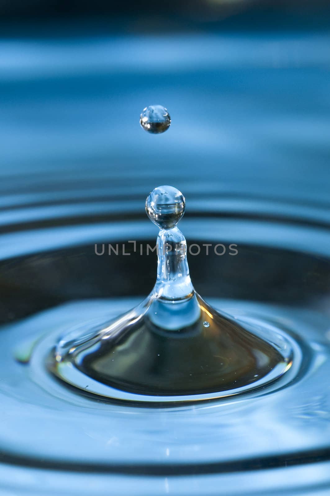 Bouncing water drops in blue background