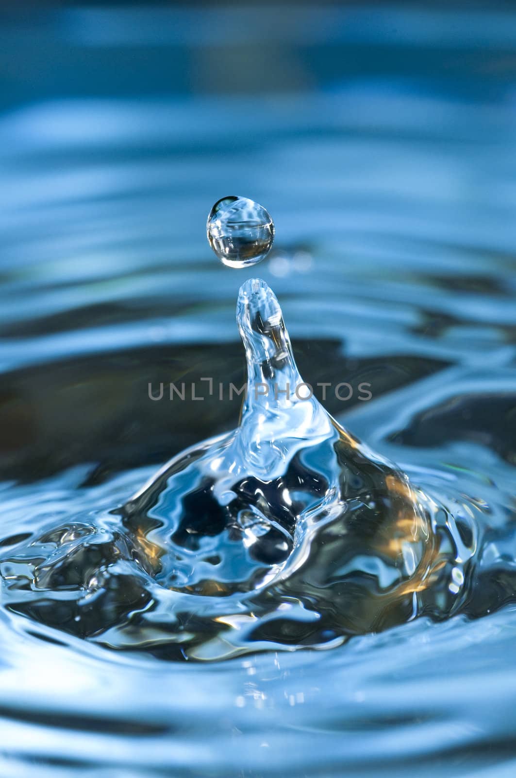 Bouncing water drops in blue background