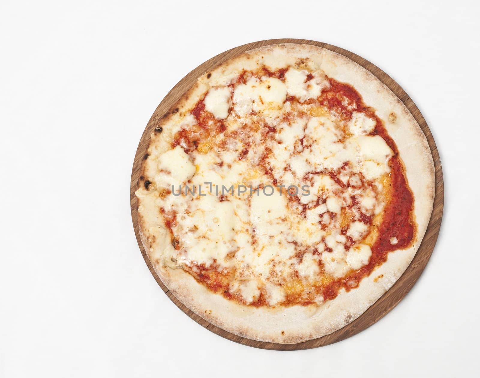 A margherita pizza on a wooden plate in white background