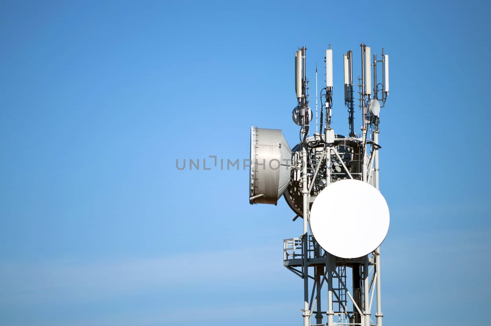 Modern antenna with flat paraobla on blue sky