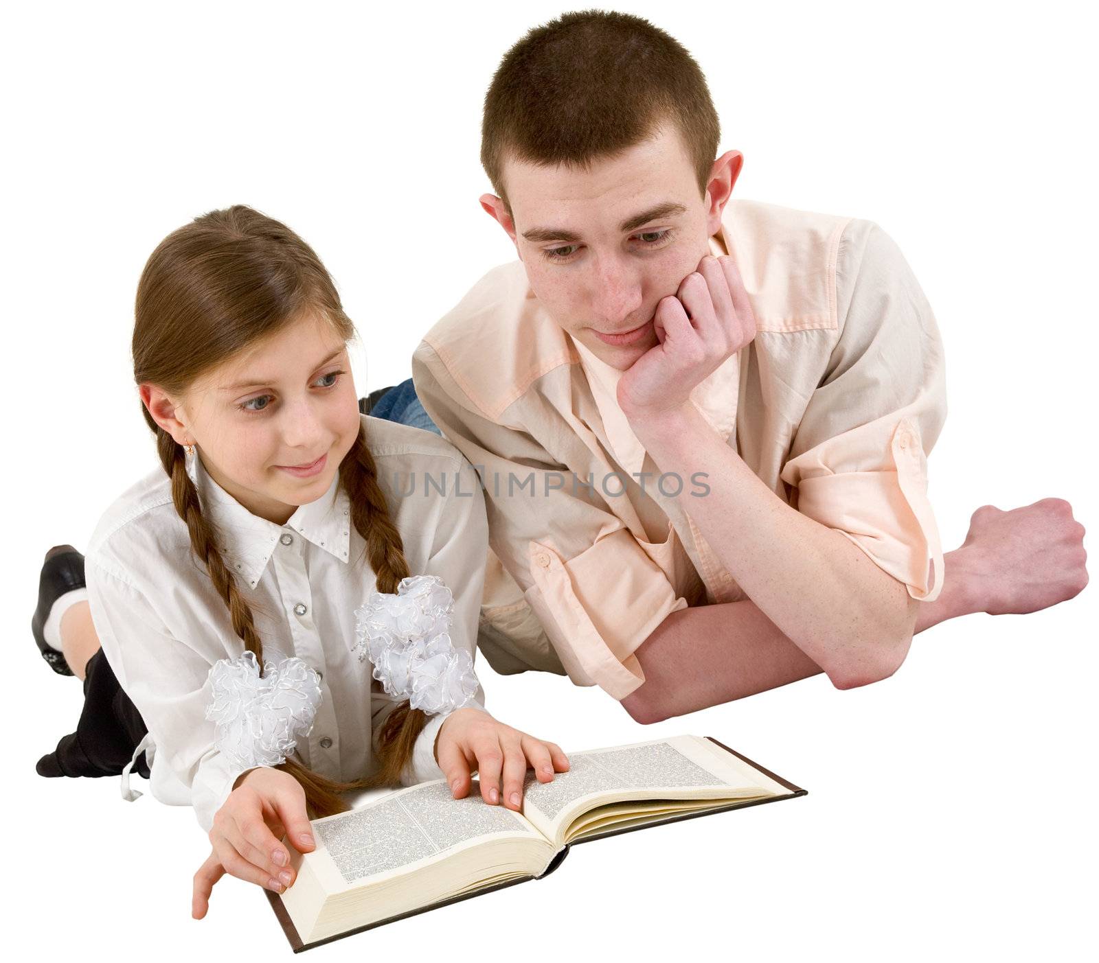 Girl and young man reading book in a reclining position on white