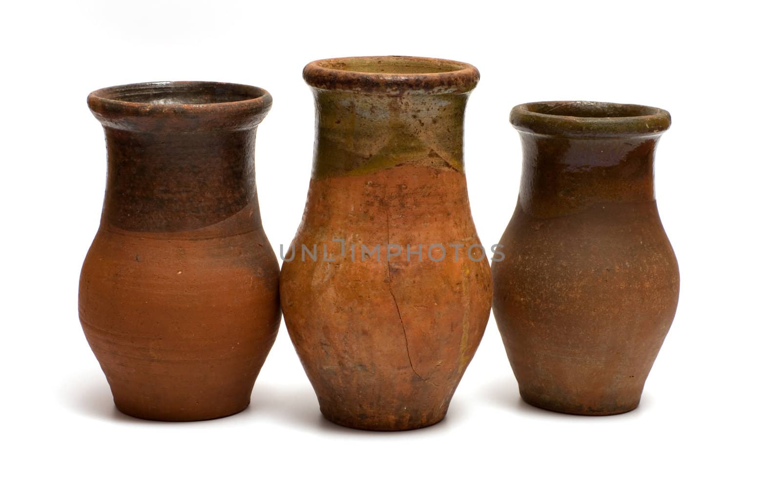 Three of the old earthen bowls isolated on a white background.