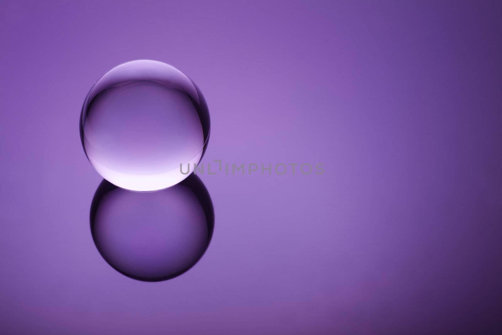 Clear ball floating on a purple gradient
