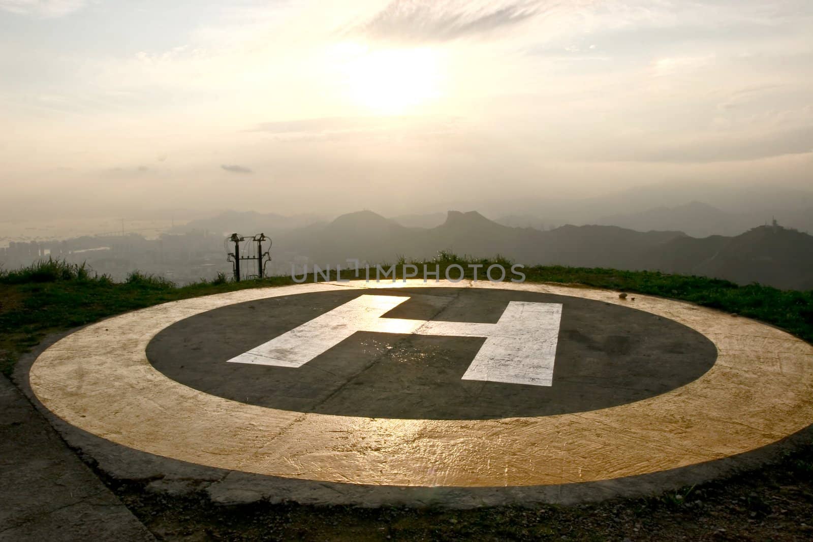 A peak helipad under sunset