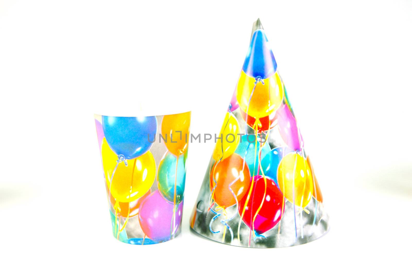 Party cups and hats isolated against a white background