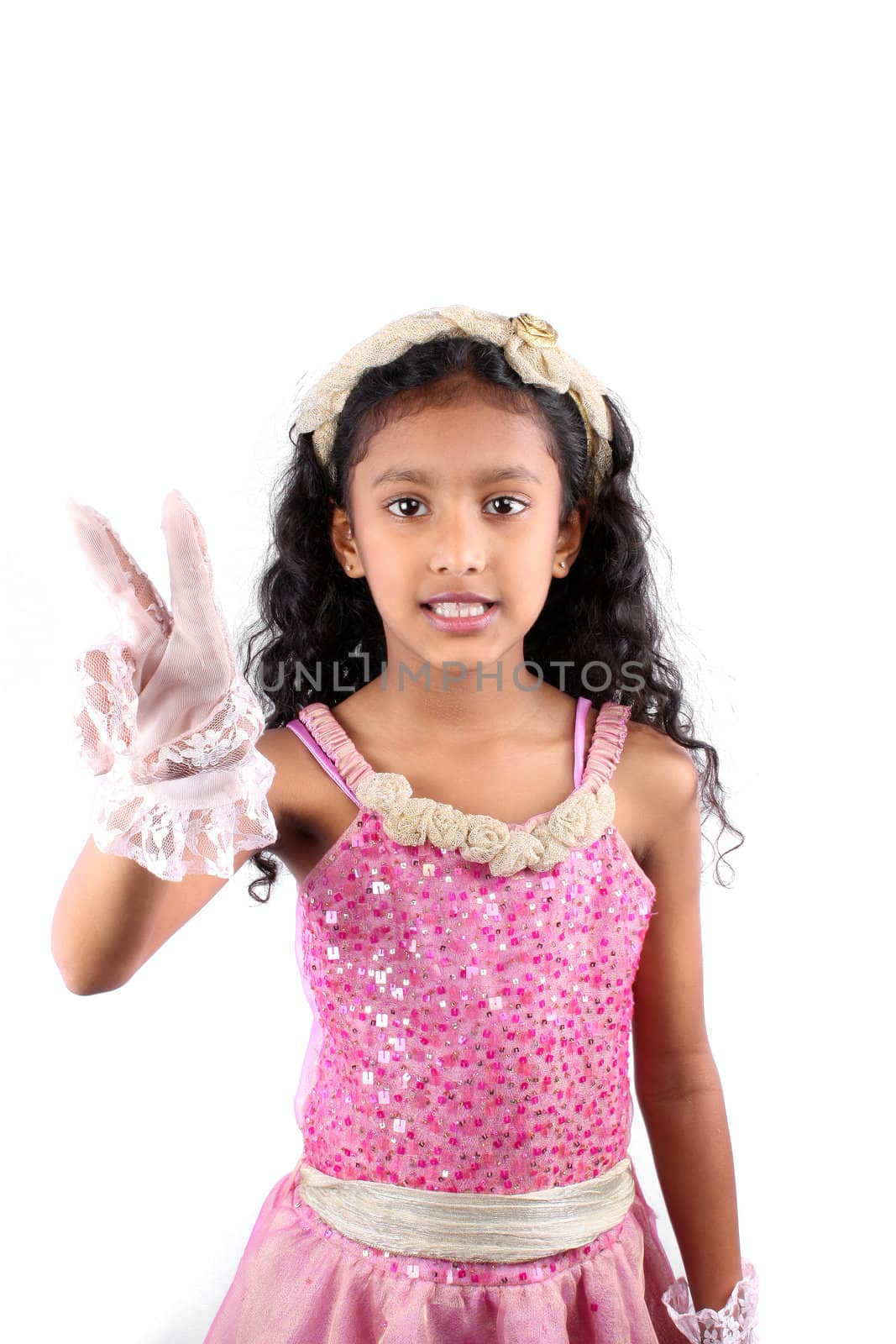 A little Indian girl wearing a white glove wishing victory, on white studio background.