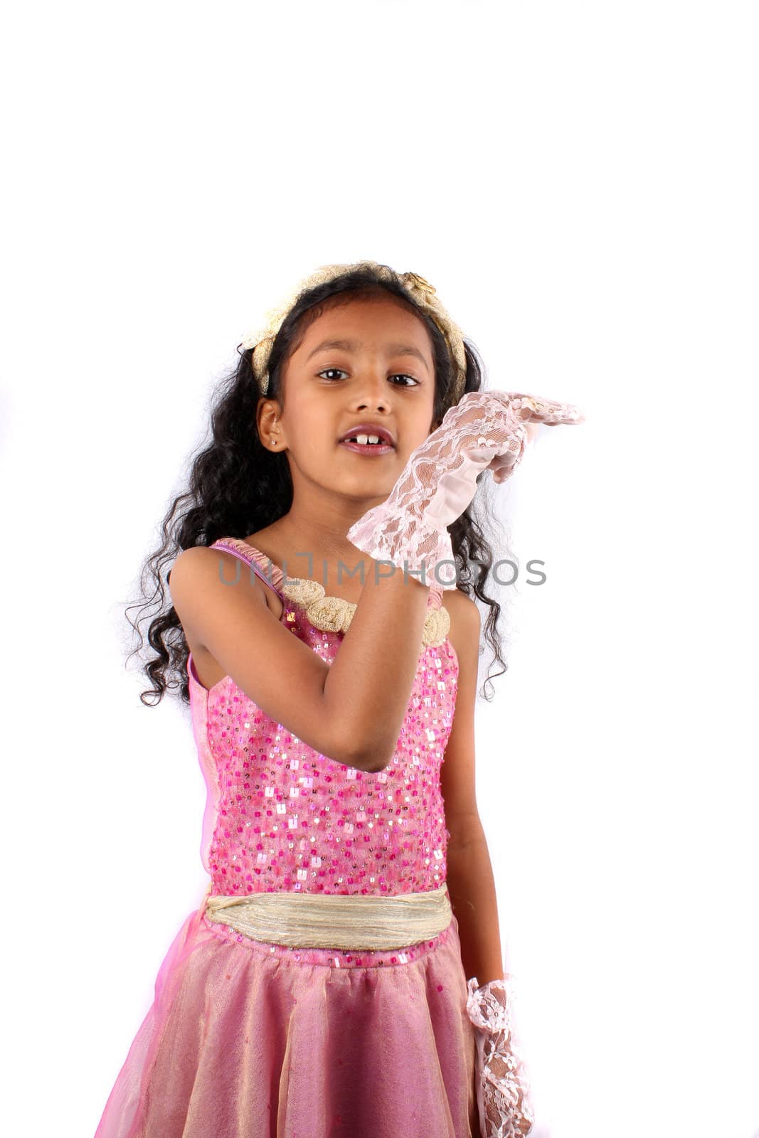 A cute Indian girl wearing gloves showing the right direction, on white studio background.