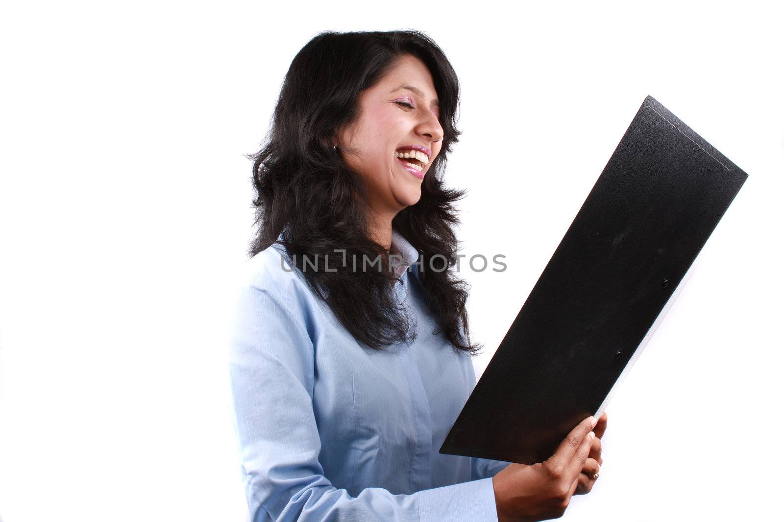 A metaphorical portrait of an Indian businesswoman sarcastically laughing looking at a business offer document, on white studio background.