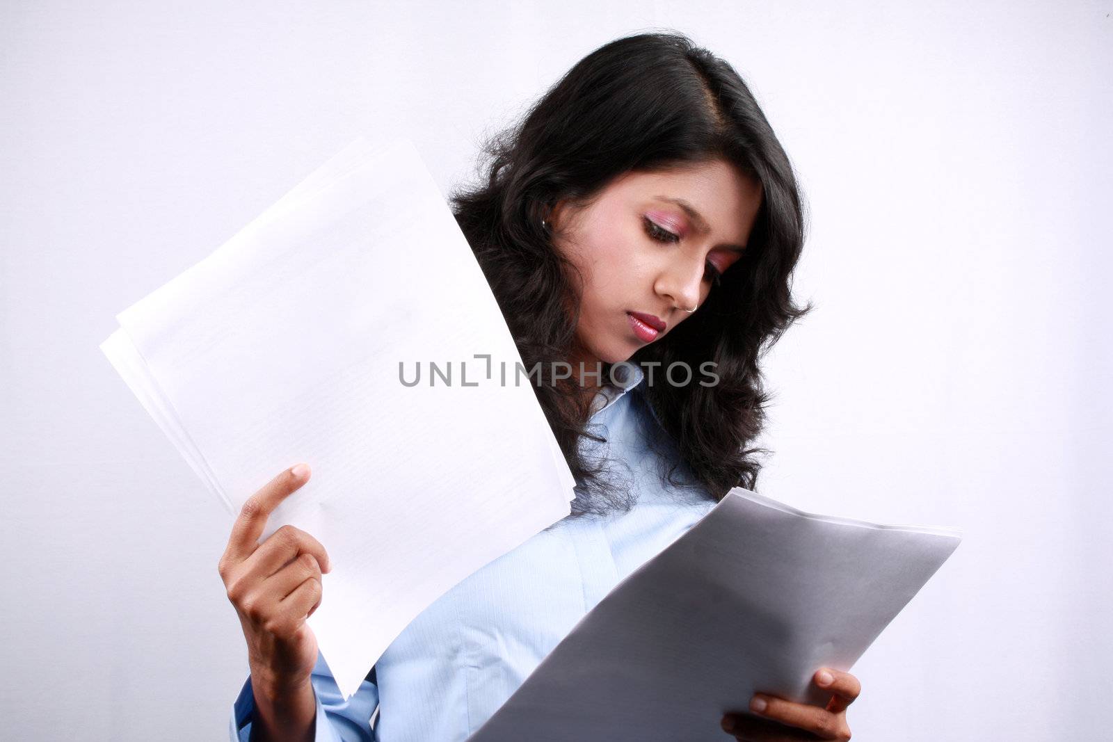 A young Indian businesswoman checking business documents.