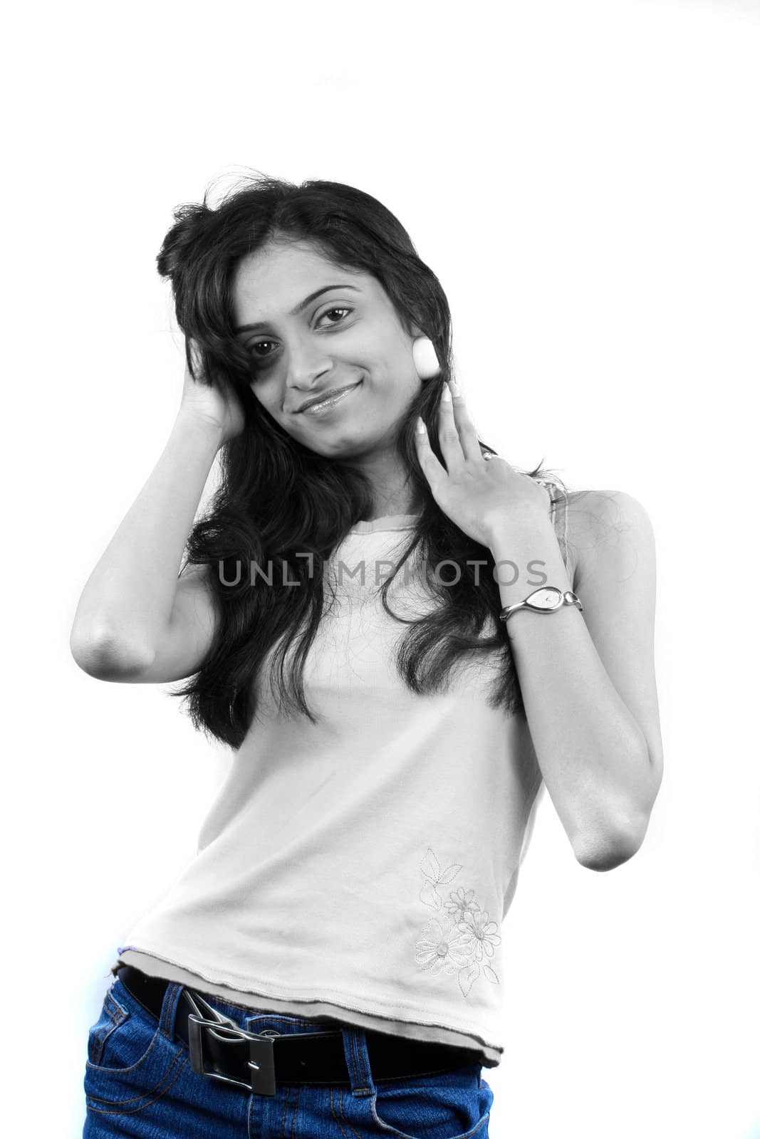 A glamorous Indian model wearing a blue denim jeans, on white studio background.