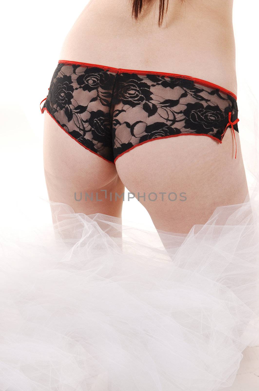 The bottom of a young woman with black lace panties standing in
white twill, like clouds, for white background.
