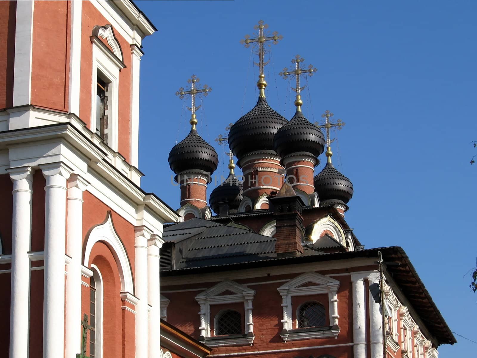 Red Russian church on a background of blue sky