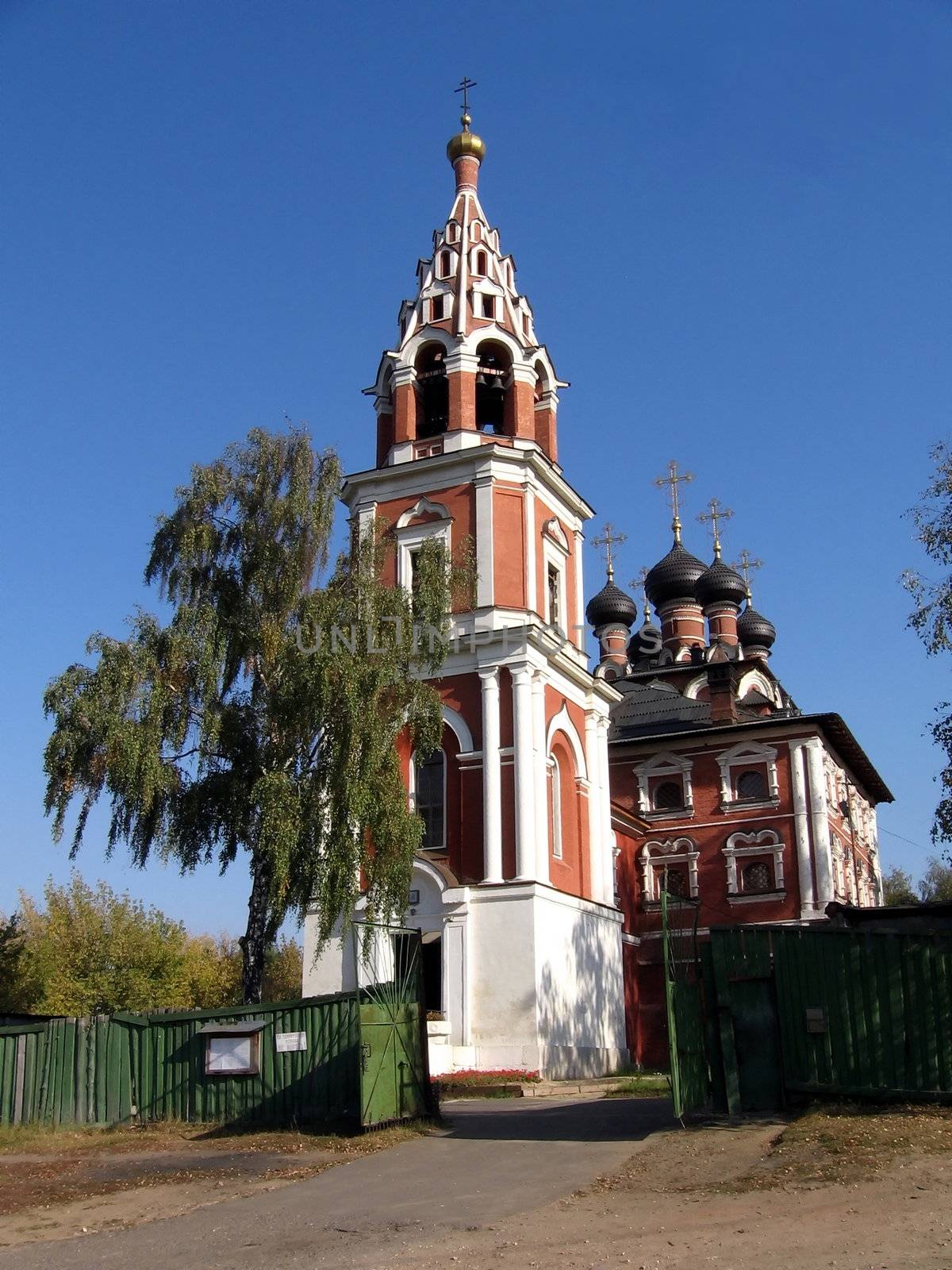 Red Russian church on a background of blue sky