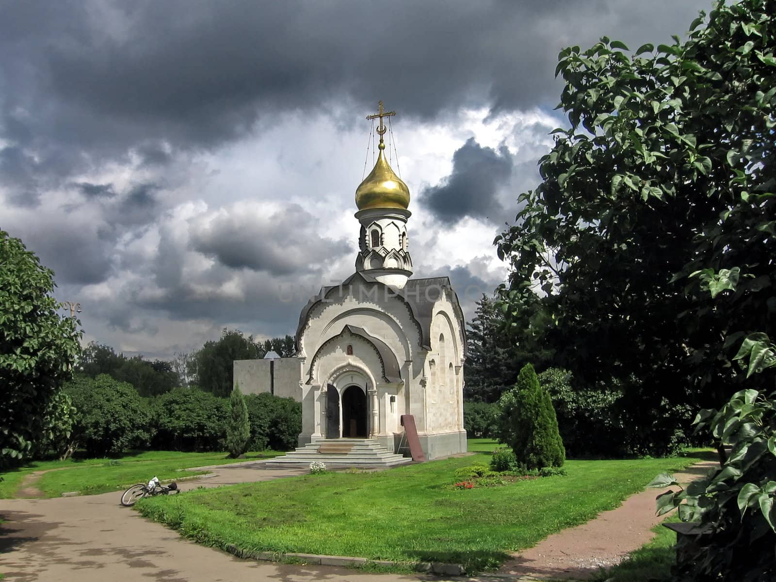 Small Russian church on a background of thunder clouds