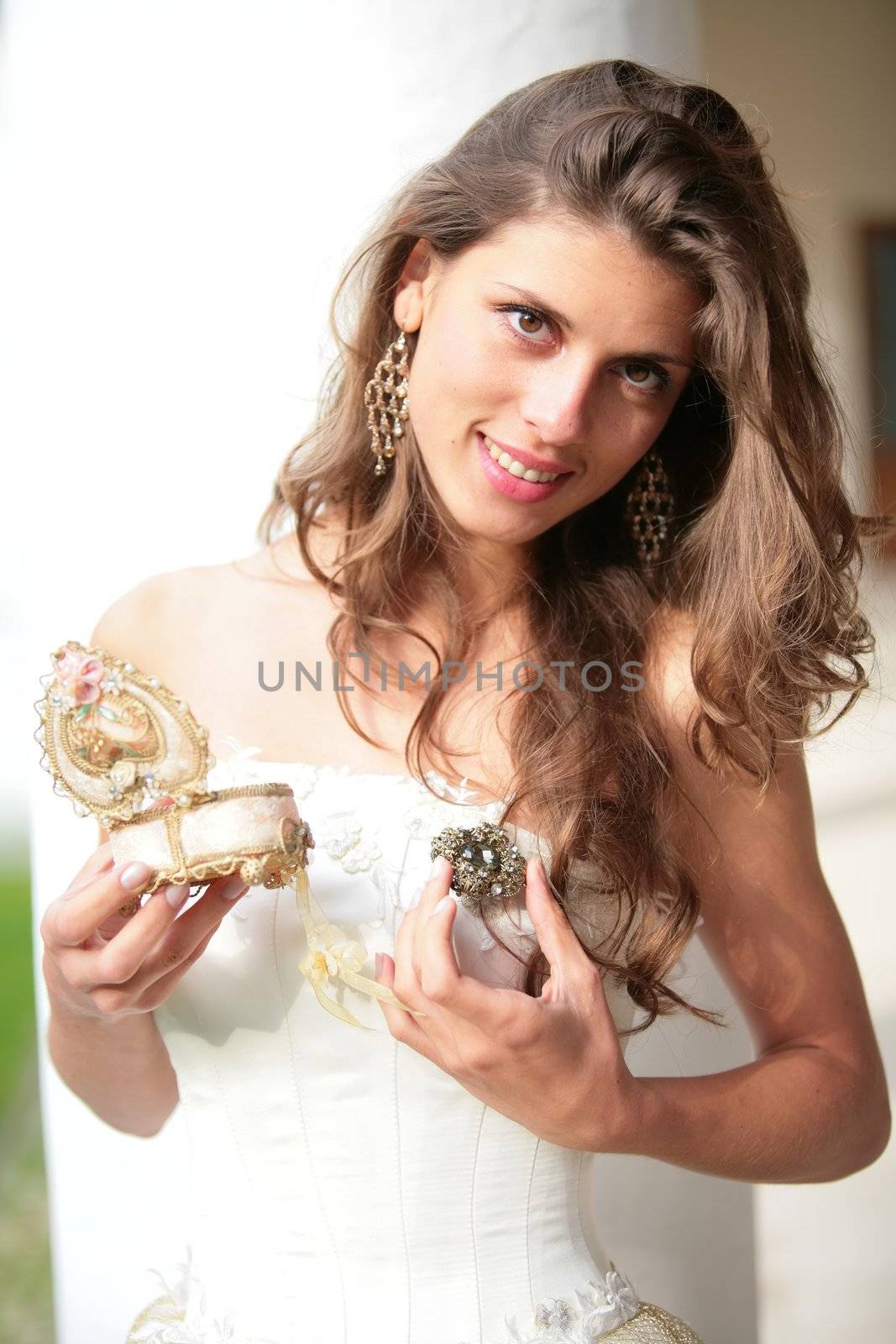 the young girl in white-golden gown with gift in hand