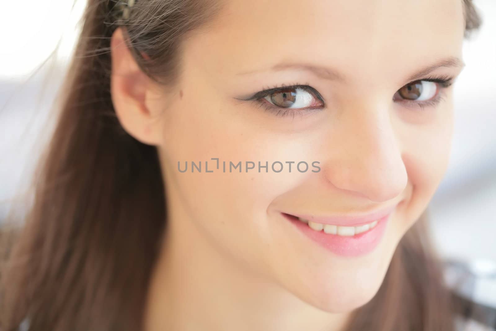 young and merry girl with brown hair, closeup portrait