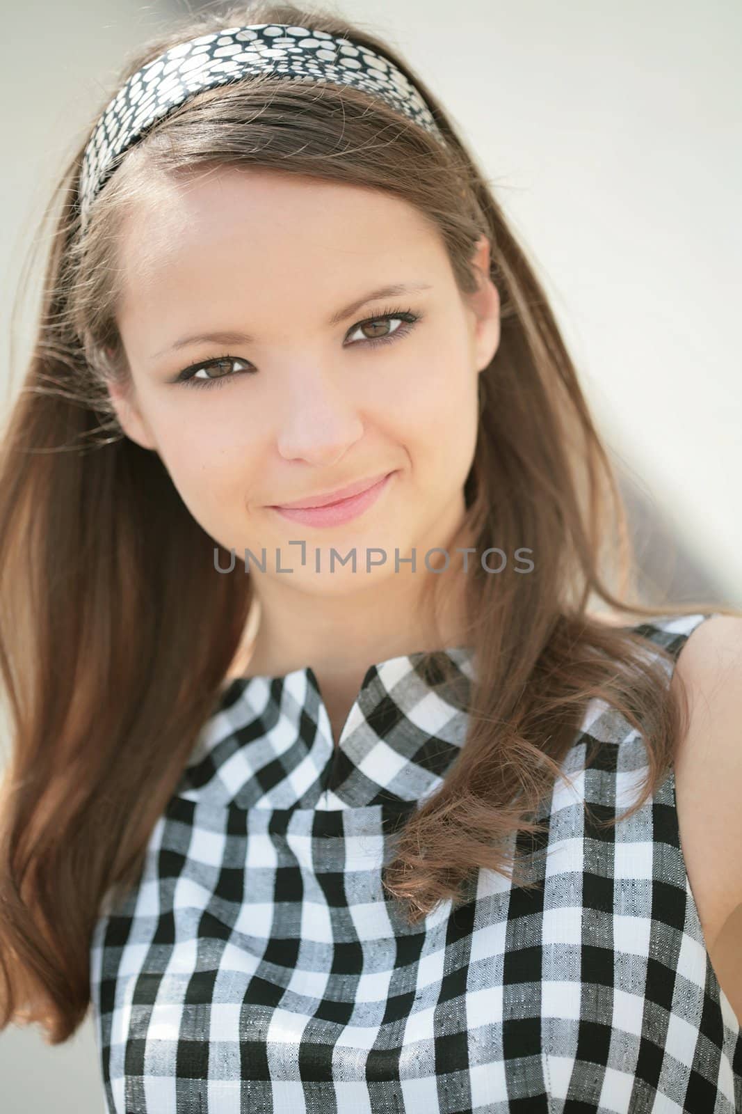 close-up portrait nice smiling girl in plaid dress