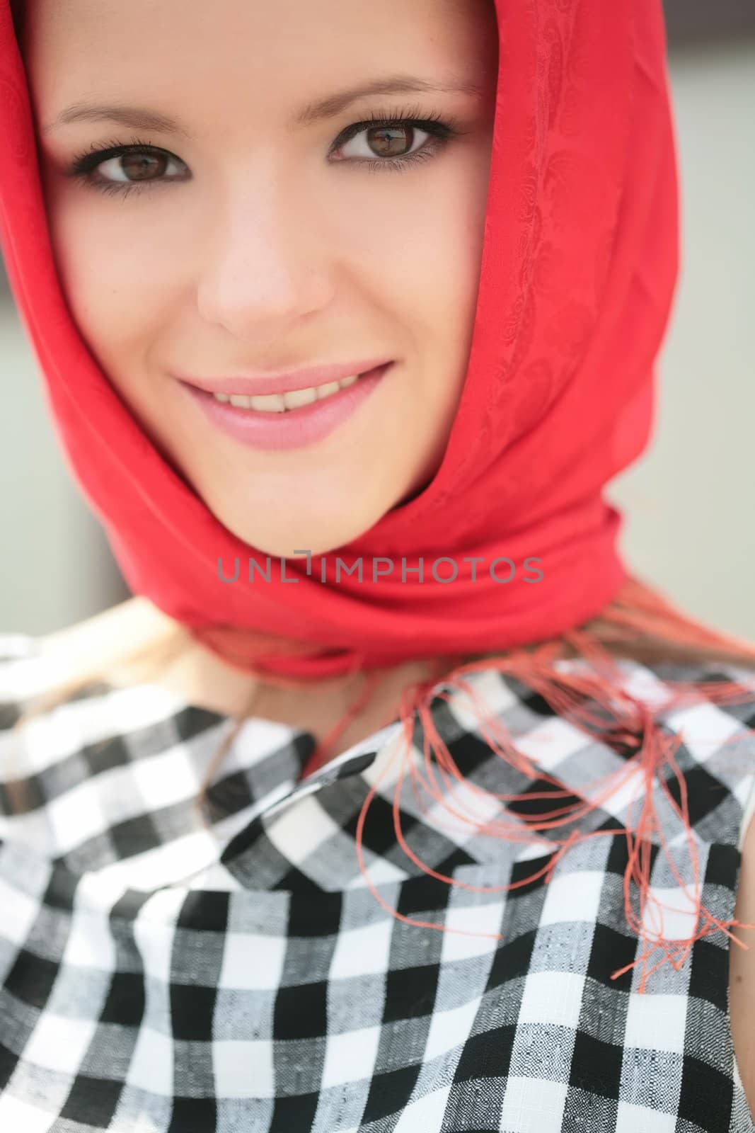 close-up portrait of the beautiful girl in plaid gown with red kerchief