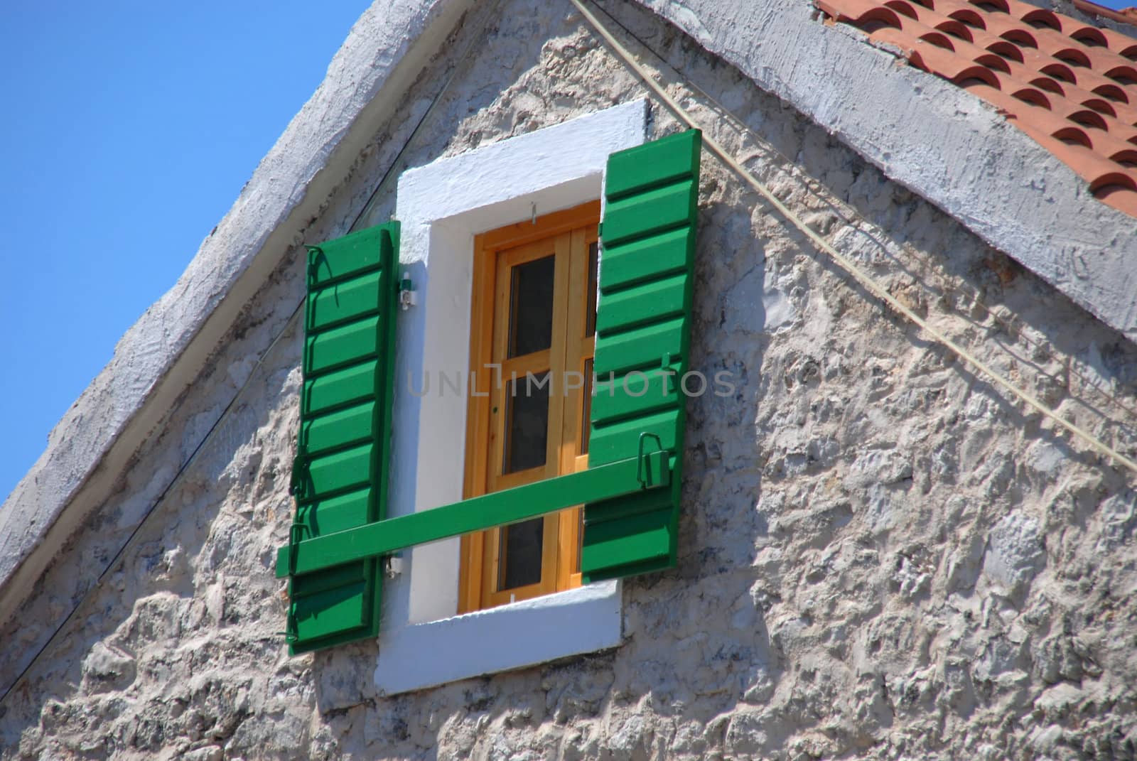 The open green shutter in the window. Croatia. by wojciechkozlowski