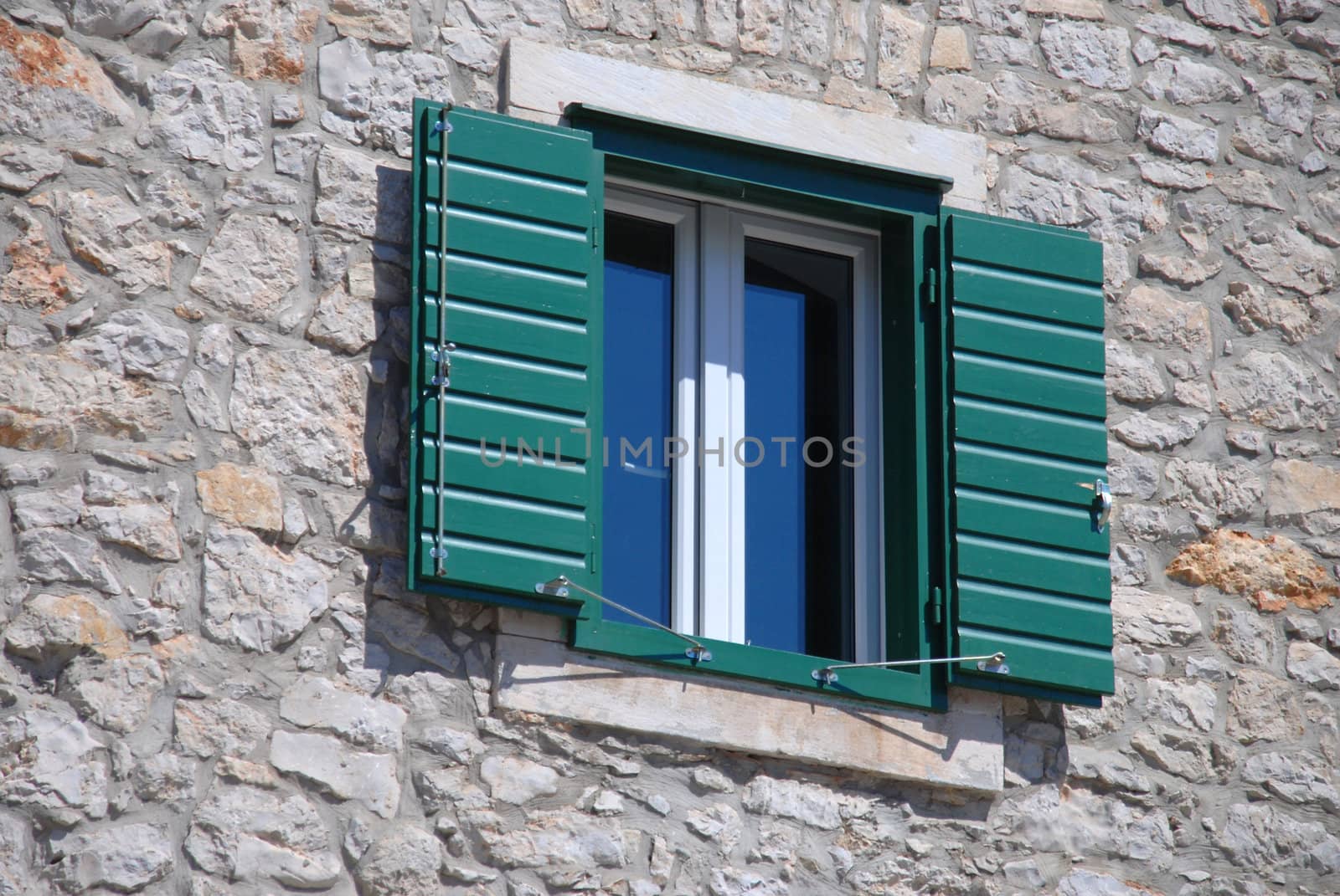 The open green shutter in the window. Croatia, Vodice.