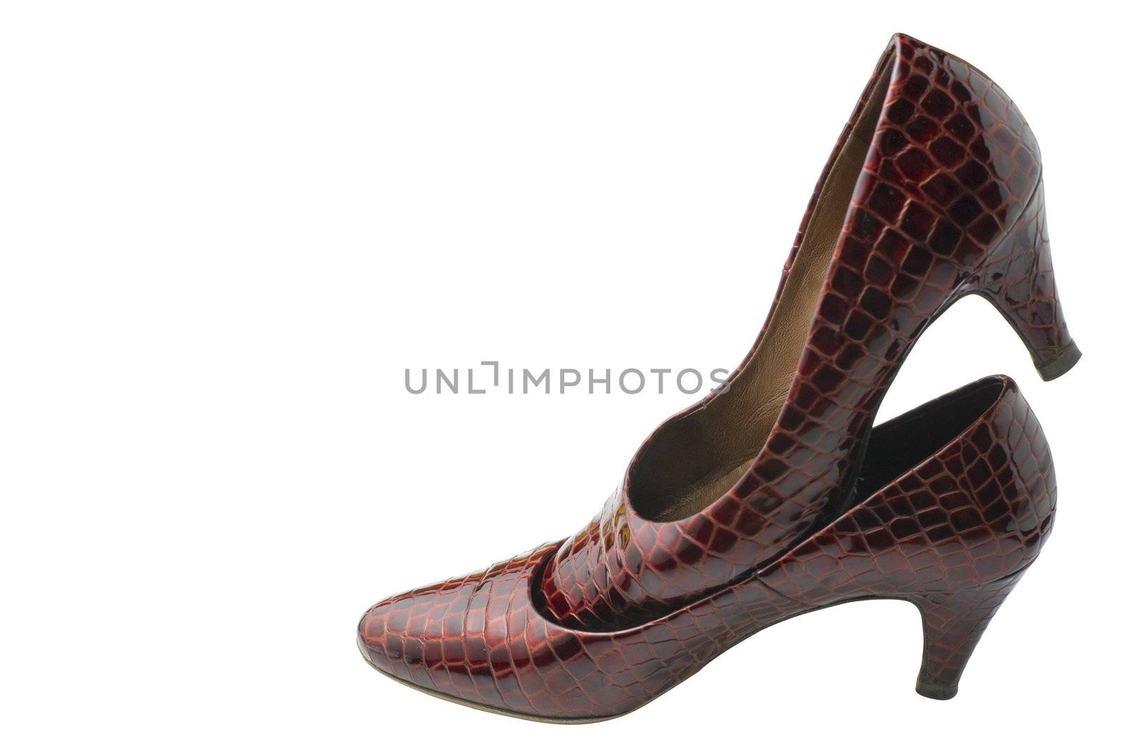 Female shoes made of red artificial crocodile leather . Isolated on white background.