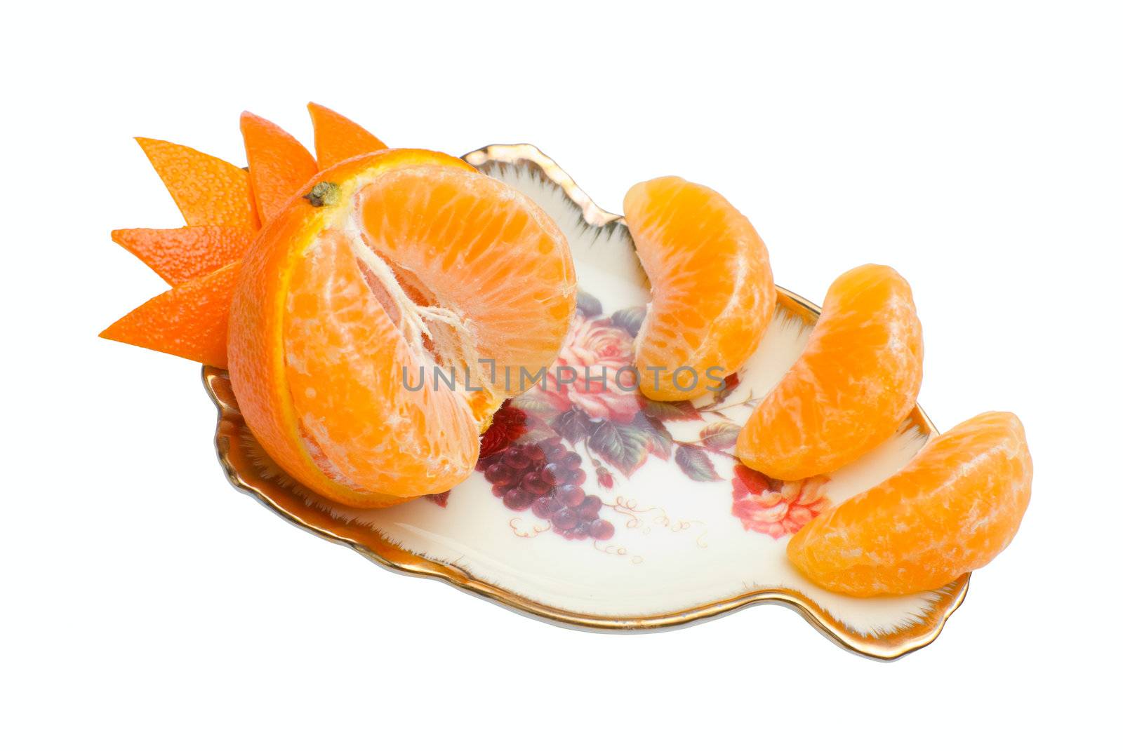 Orange tangerine devided into segments and decorated with peel on beauty fruit dish. Isolated on white background
