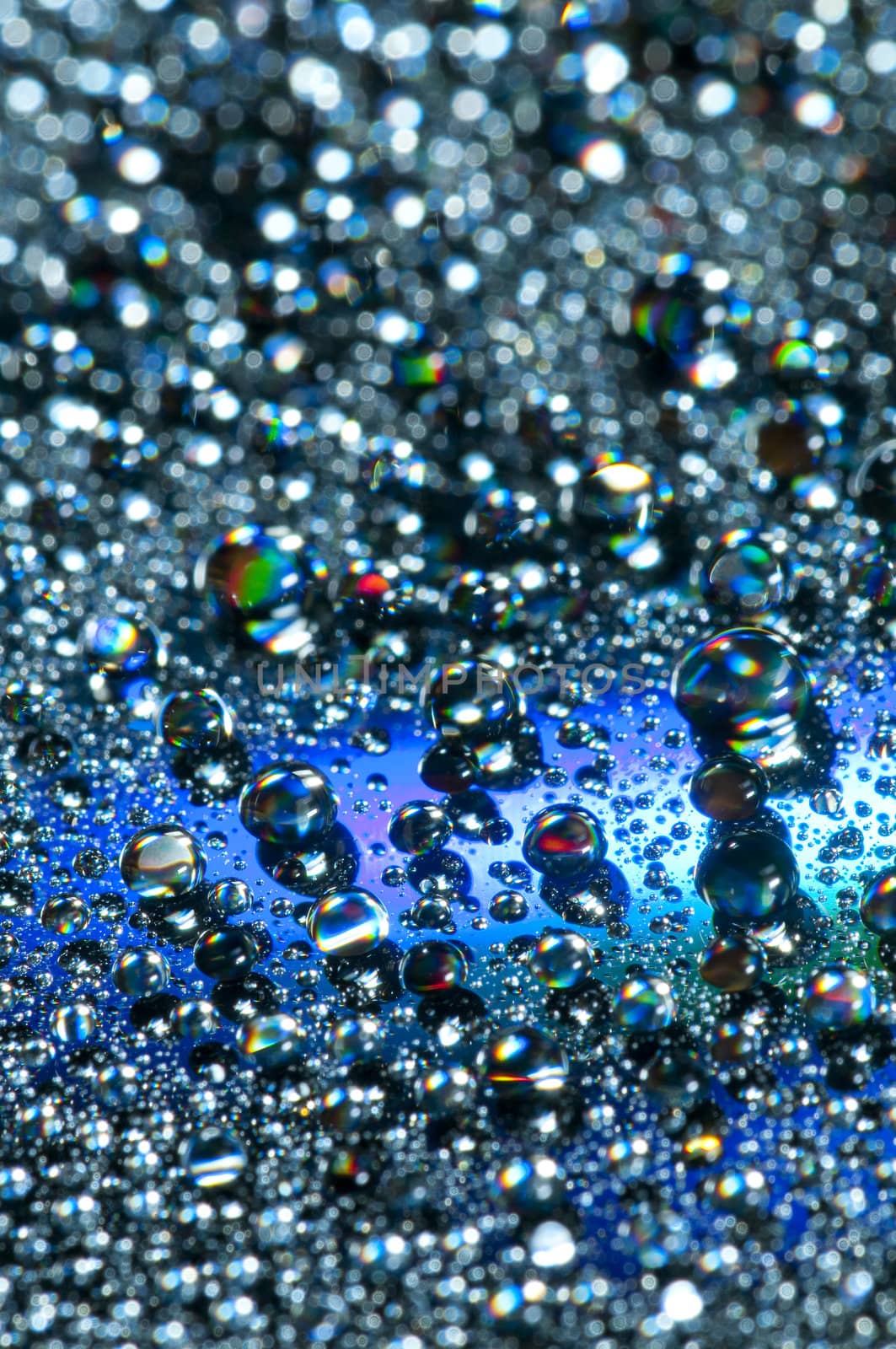 Water drops on colorful reflective surface
