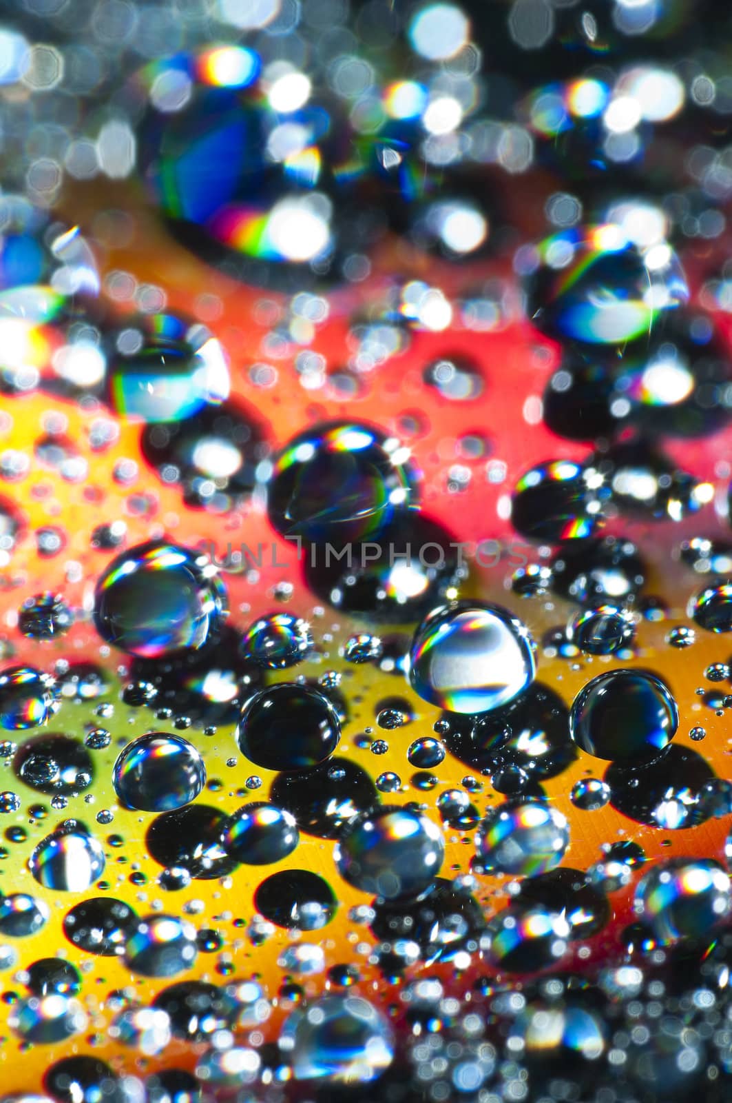 Water drops on colorful reflective surface