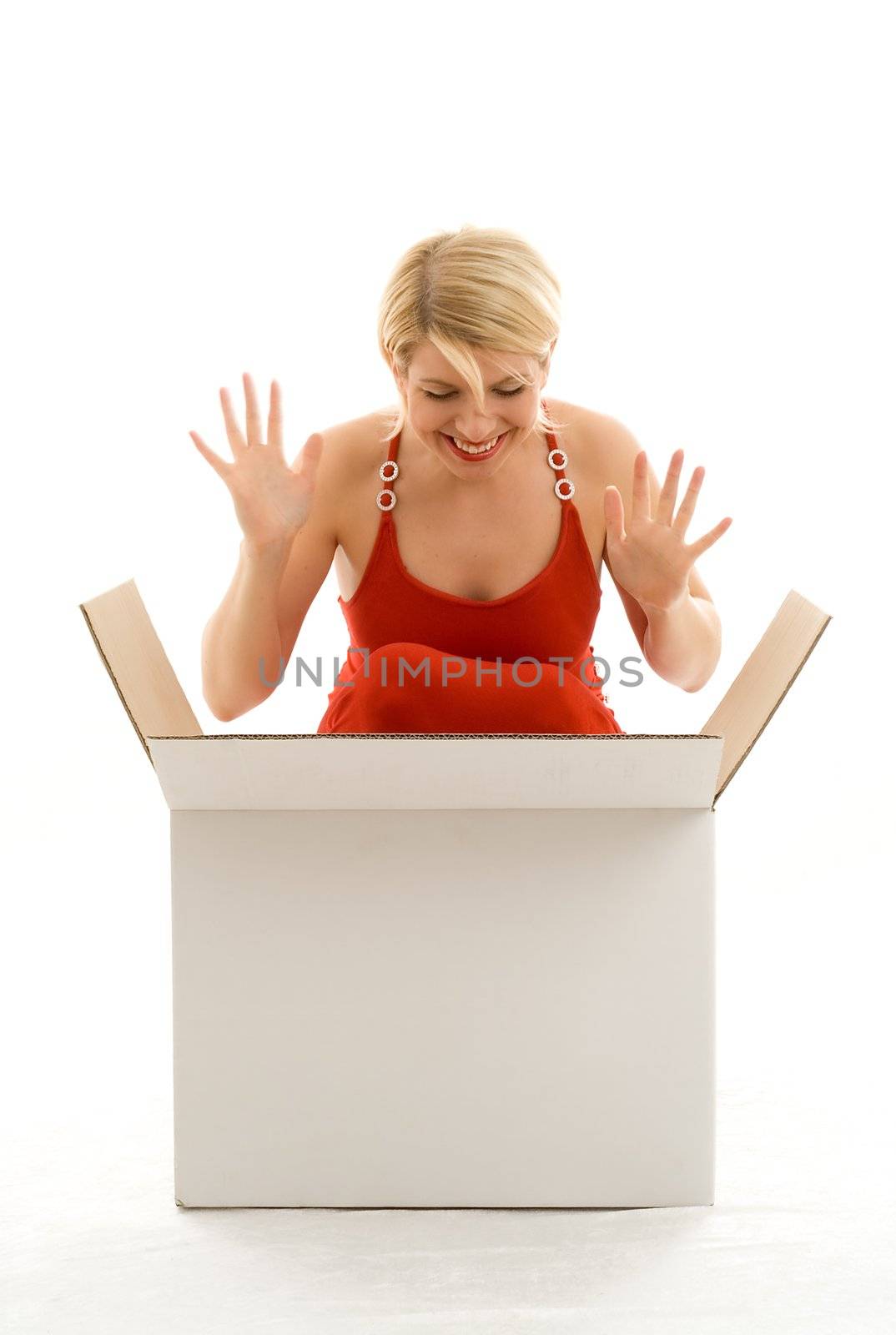 Happy girl in red dress with big white box