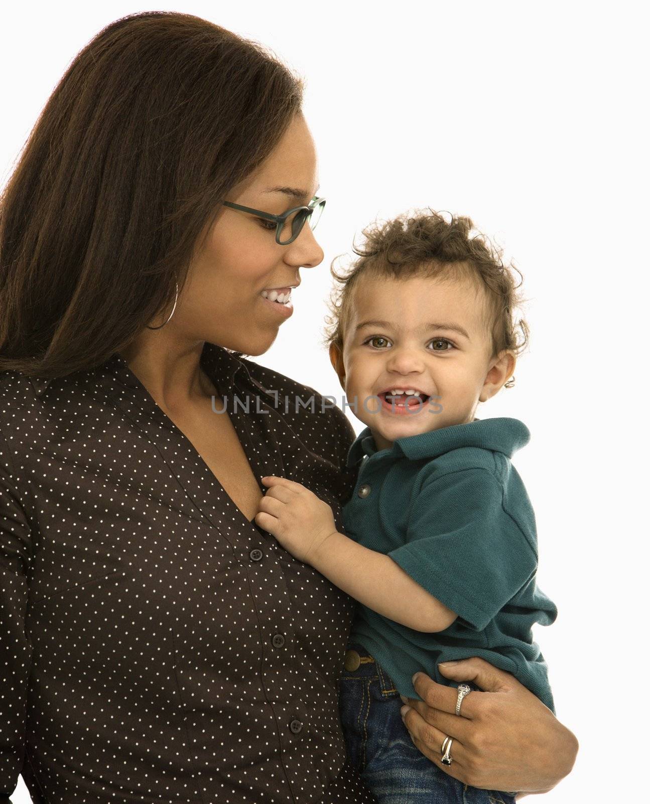 African American mid adult mom holding toddler son with happy expression.