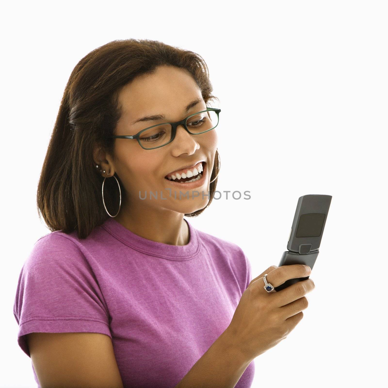 African American mid adult woman wearing glasses smiling at cell phone.