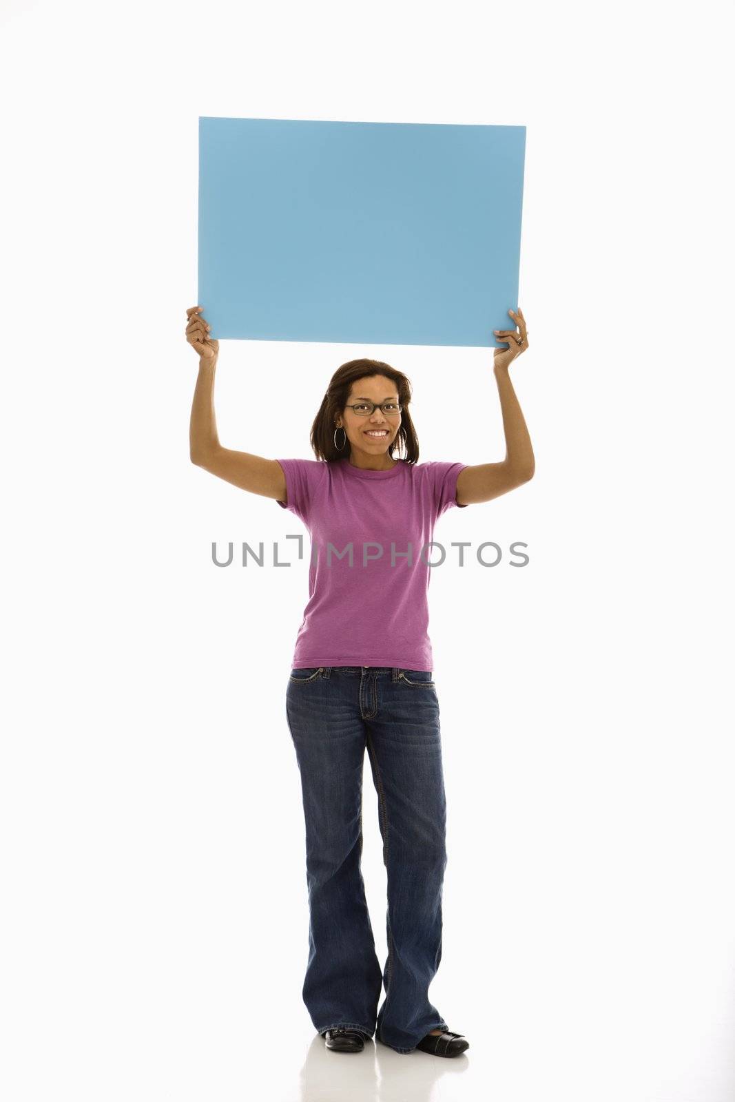 Woman holding sign. by iofoto