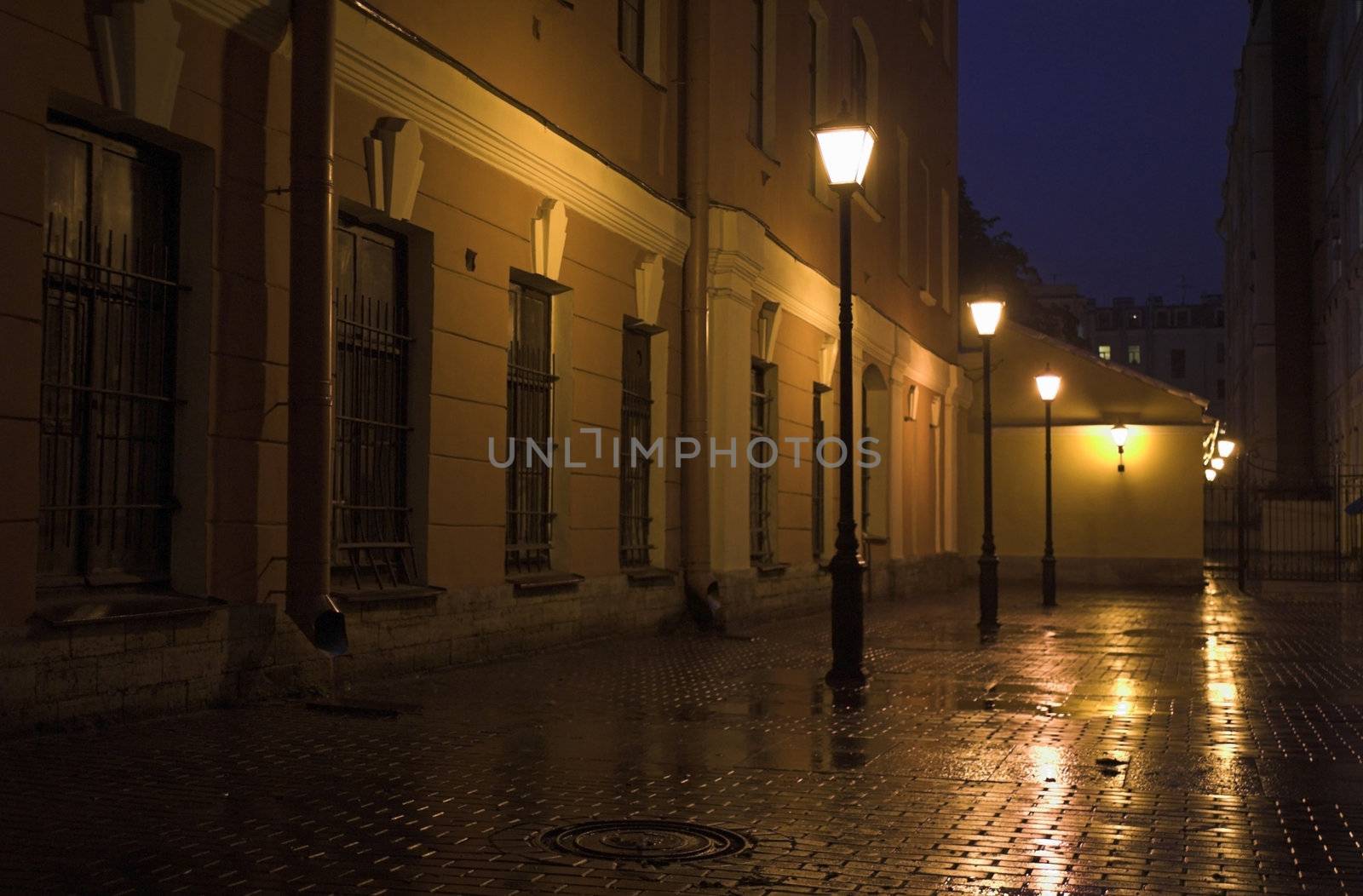Yard with street lamps and stone pavement at evening in Saint Petersburg, Russia.