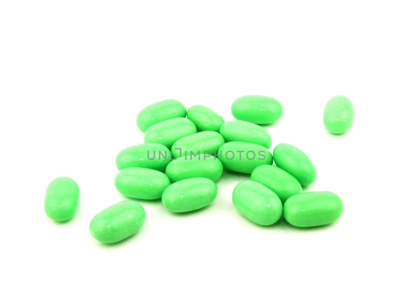 Green candies on white background