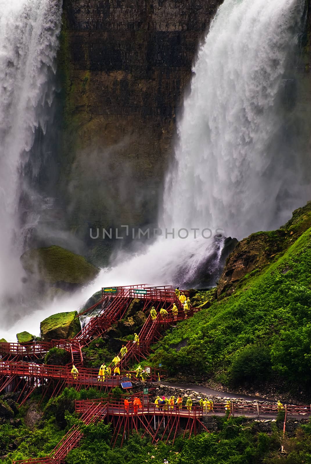 People walking near the base of Niagara Falls. 