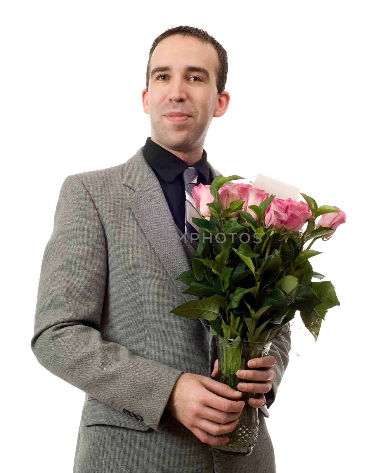 A young man holding a vase of roses, isolated against a white background