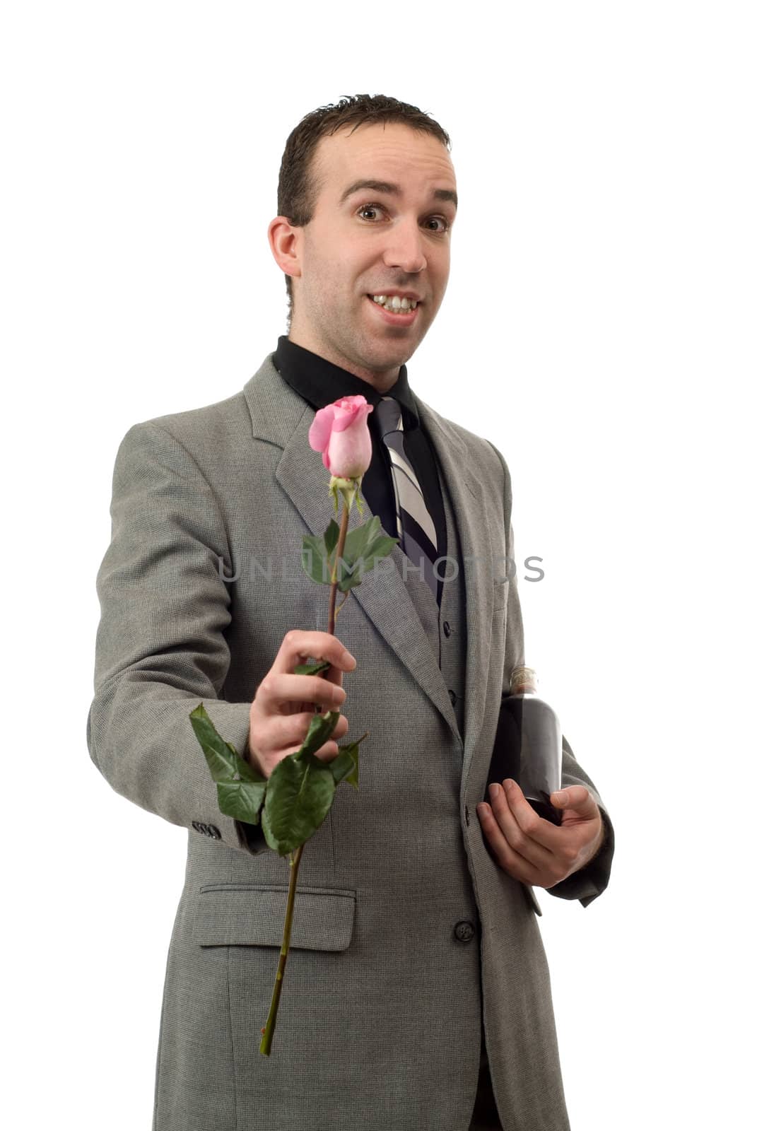A man wearing a suit and tie, holding a rose and a bottle of champagne, isolated against a white background