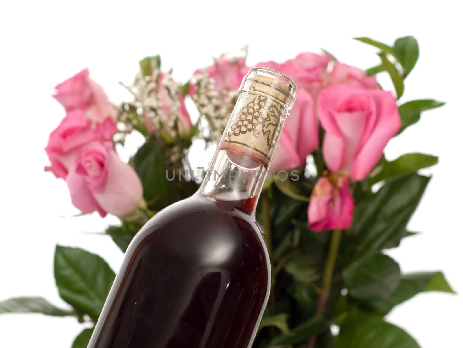 Closeup view of a bottle of champagne and some roses, isolated against a white background