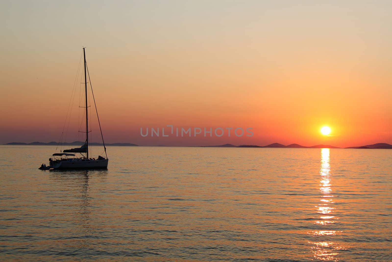 Romantic sunset with silhouette of yacht