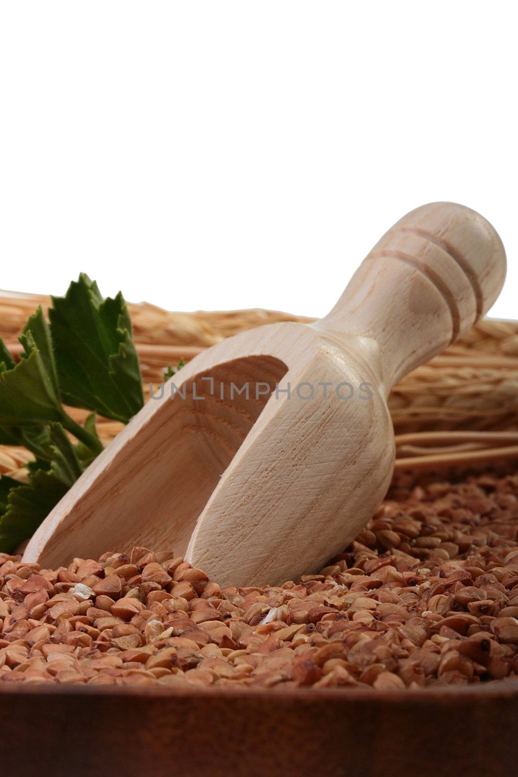 Buckwheat groats with a wooden deep spoon for packaging.