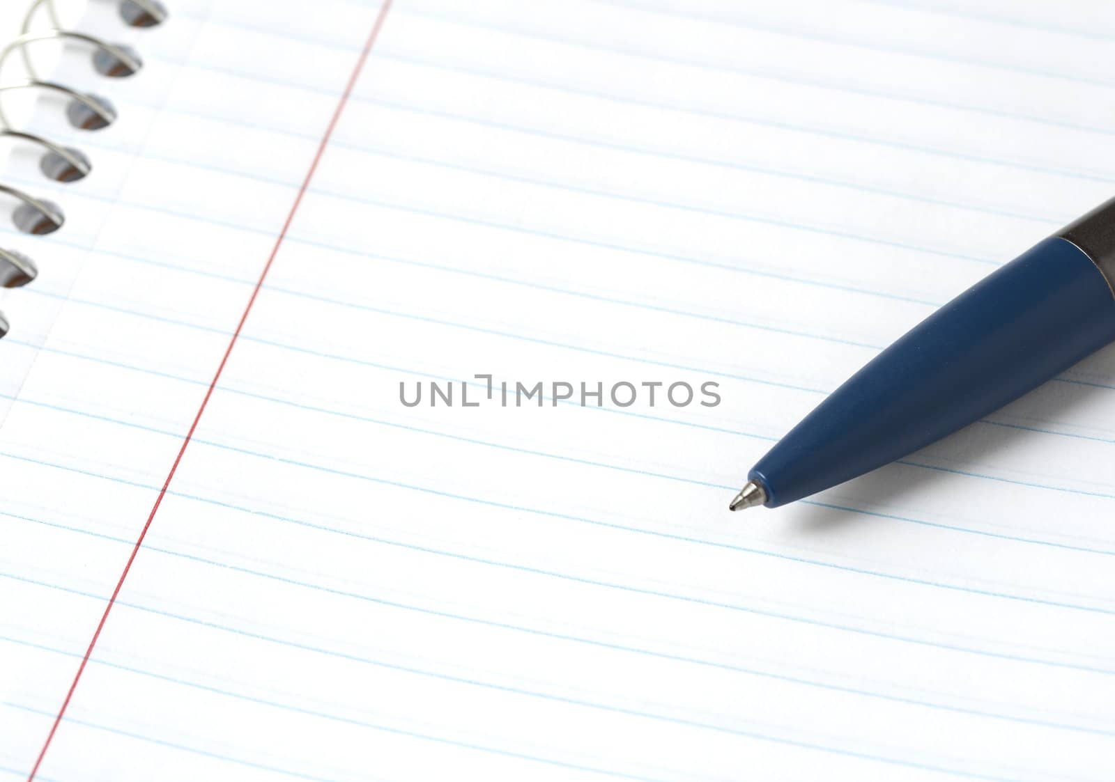 a macro picture of a pen and notebook