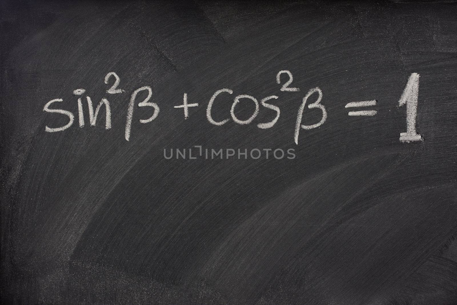 Pythagorean trigonometric identity handwritten with white chalk on a blackboard