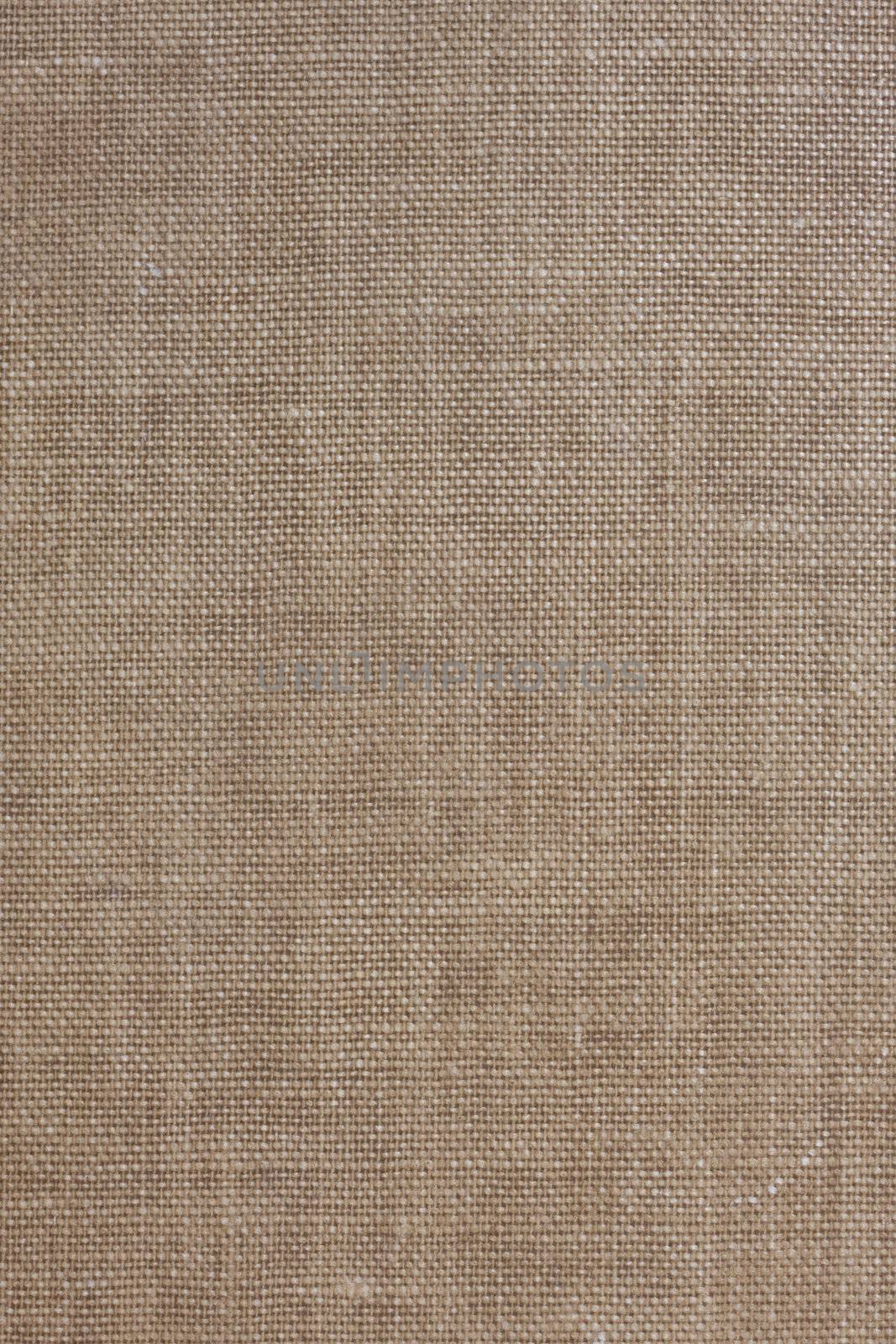 brown textile background from a vintage book cover with some stains and scratches