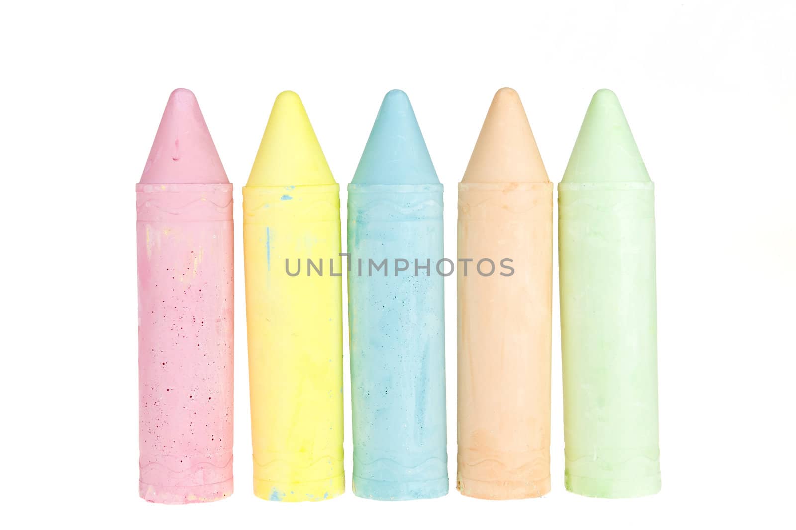 five colorful chalks on a white background