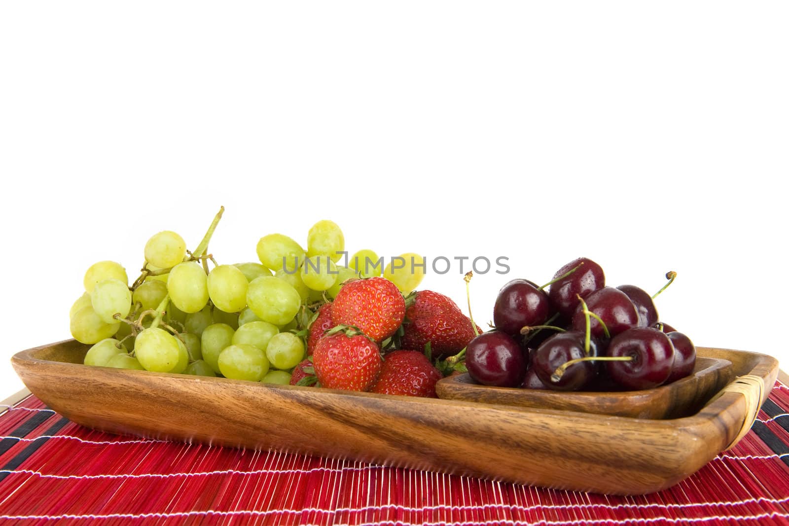summerfruit in a wooden tray on a red plaid