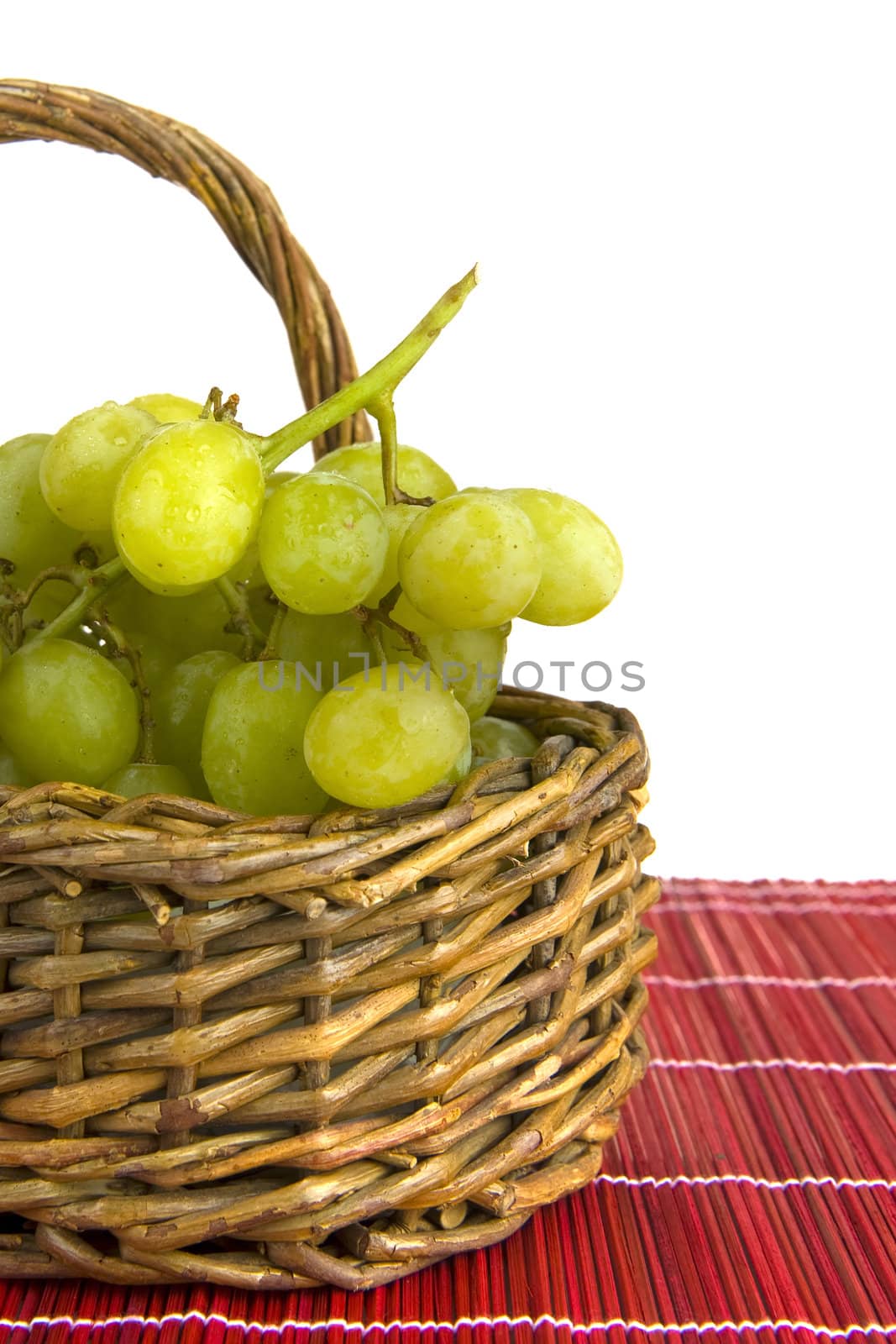 grapes in a basket on a red plaid