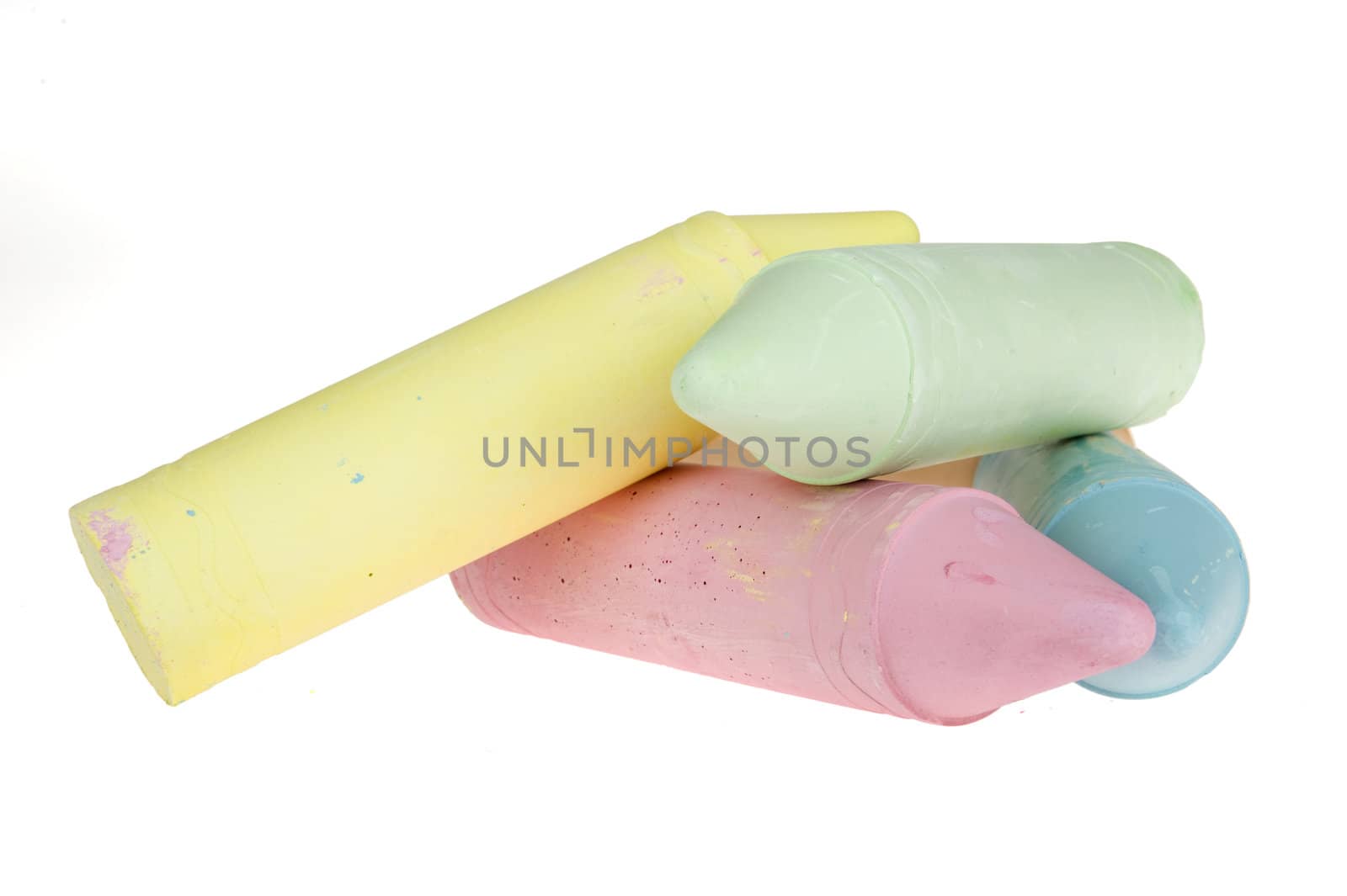 five colorful chalks on a white background