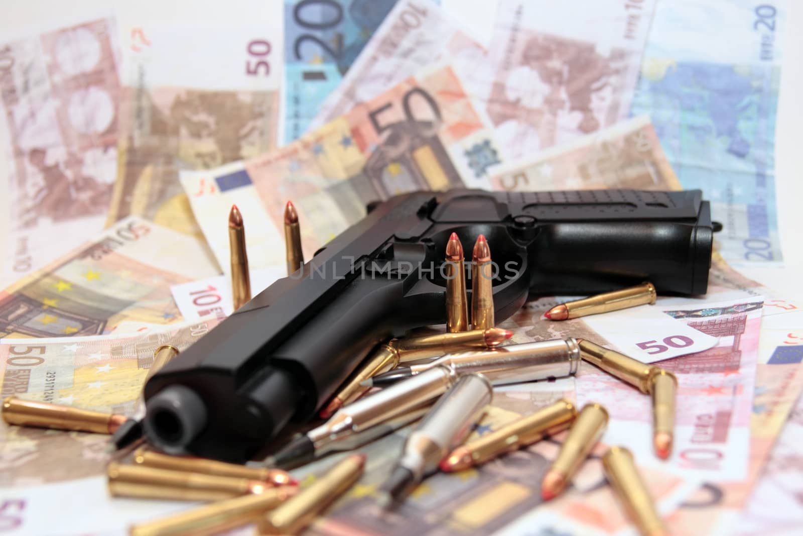 gun bullets and money showing a dangerous side to life